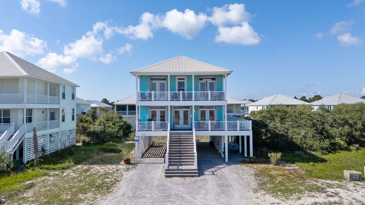 This home stands out from the others with it's light blue exterior
